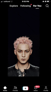a cellphone screen displays a picture of a man with pink hair