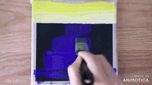 a person is using a brush on a piece of paper that says made in animonica