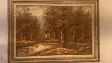 a framed painting of trees and a house