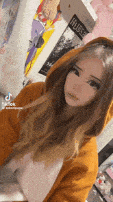 a girl wearing a hoodie is taking a selfie in a room .