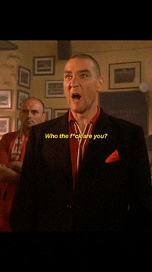 a man in a suit says " who the fuck are you "