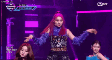 a woman with red hair is standing on a stage with a microphone .