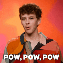 a man in a colorful shirt with the words pow pow pow behind him