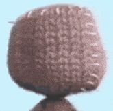 a close up of a knitted object with stitches on it .