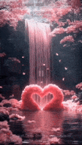 a waterfall with a heart made out of pink flowers