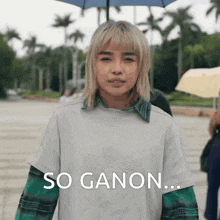 a woman with blonde hair is holding an umbrella in the rain .