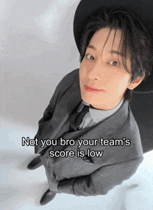 a man in a suit and hat with the words not you bro your team 's score is low