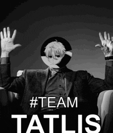 a man in a suit is sitting in a chair with his hands up in the air and the words #team tatlis behind him