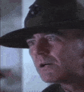 a close up of a man wearing a hat
