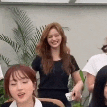 a group of women are standing next to each other and smiling .