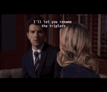 a man in a suit and tie is talking to a woman and the words ruth bader and ginsburg are on the screen