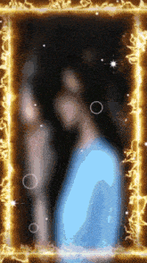a blurry picture of a man in a blue shirt with a gold frame around him