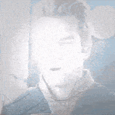a close up of a man 's face with a blurred background .