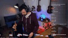 a man wearing headphones is playing a game on a screen that says ' twitch ' at the top