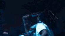 a man in a white shirt is singing into a microphone with a sign that says campbella on it