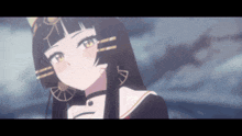 a close up of a girl with long black hair and earrings