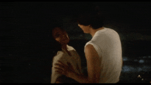 a man and woman are dancing with their arms in the air