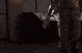 a man in a robotic suit is holding a flamethrower in a dark room