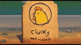 a wooden tombstone with a yellow chicken and the words " lucky " written on it