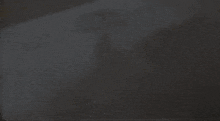 a blurry picture of a person 's face in a dark room .