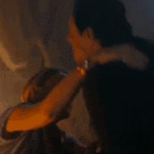 a man with a watch on his wrist is being held by a woman