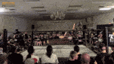 a crowd of people watching a wrestling match with #a1wrestling written on the corner