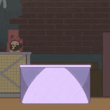 a purple box is sitting on a table in front of a brick wall