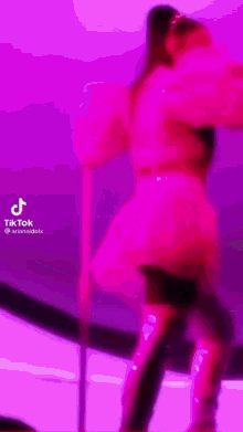 ariana grande is wearing a pink dress and thigh high boots