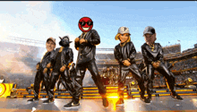 a group of people are dancing in a stadium and one of them has a p on his hat