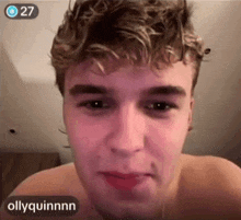 a close up of a man 's face with ollyquinnn written on the bottom right