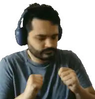 a man with a beard wearing headphones is making a fist
