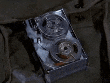 a close up of a tape recorder with two reels of tape in a box .