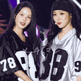 two girls wearing jerseys with the numbers 78 and 89 on them