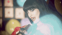 a woman holding a gun in front of a microphone