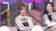 two girls on a stage with the word show in the corner