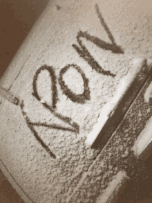 a black and white photo of a snow covered object that says ' aoov ' on it