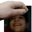 a close up of a person 's face with a hand reaching out towards it .