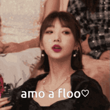 a woman in a black dress says amo a floo on her face