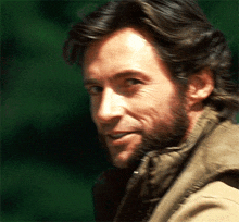 a close up of a man with a beard wearing a jacket