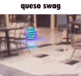 a drone is flying in a room with the words queso swag written on the bottom .