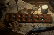 a wooden game board with a candle and a compass on a table