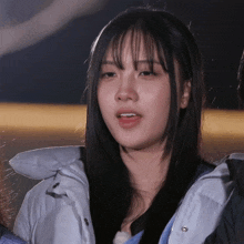 a close up of a girl wearing a jacket with a zipper