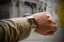 a man wearing a fossil watch looks at his watch