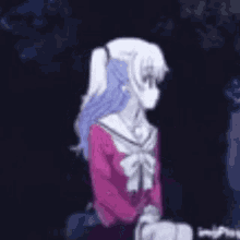 a girl in a pink shirt is standing in the dark with her arm outstretched .