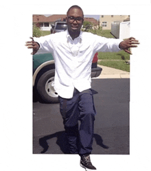 a man in a white shirt and blue pants is standing in front of a truck