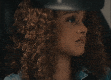 a woman with curly hair is saying go ahead and make me the bad guy