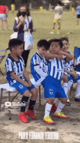 a group of young soccer players are sitting on a bench with the name paulo fernando ferreira on the bottom