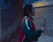 a man is wearing a red vest with the number 00 on it