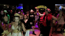 a group of people are dancing in front of a sign that says borderline on it