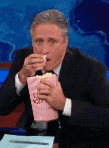 The Daily Show Eating GIF - The Daily Show Eating Popcorn GIFs